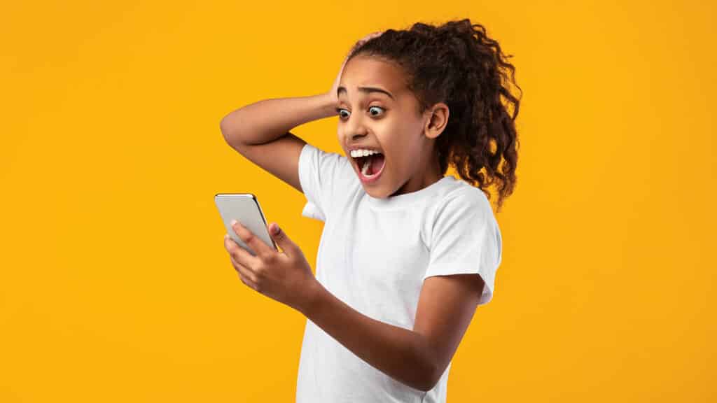 girl screaming looking at cell phone