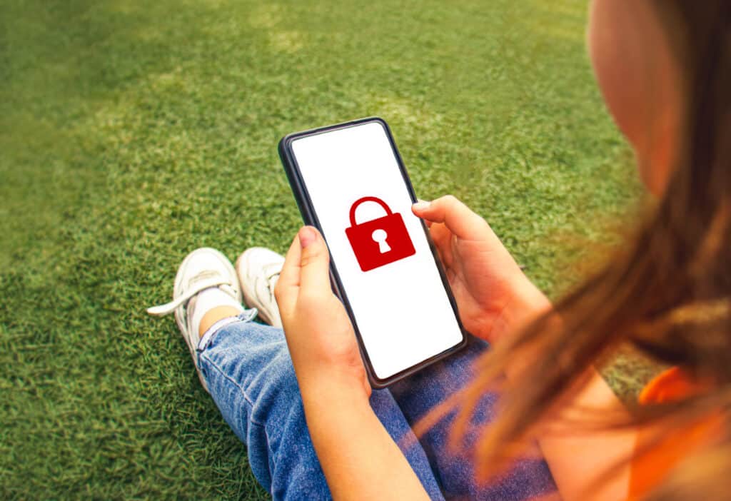 child holding phone with lock screen