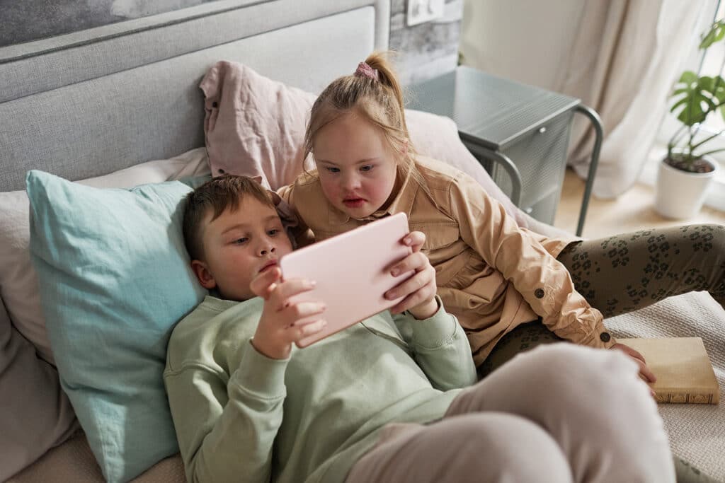 two kids watching an ipad