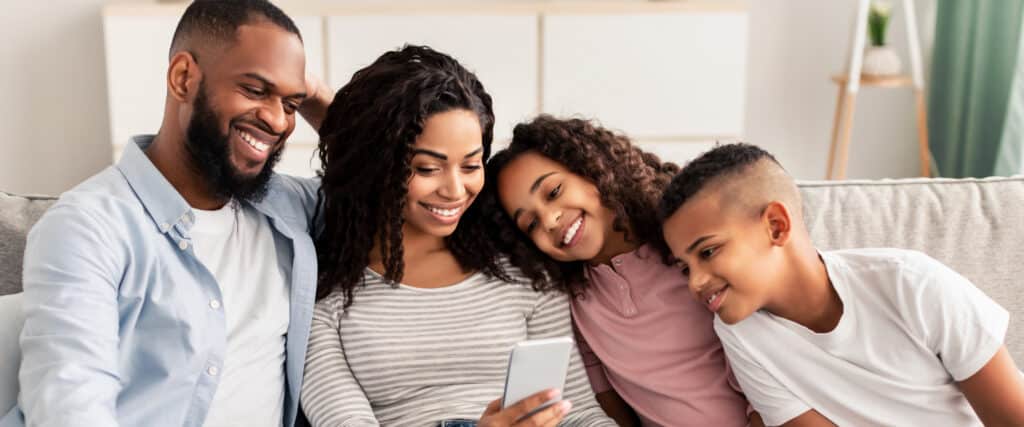 Happy family monitoring child's phone
