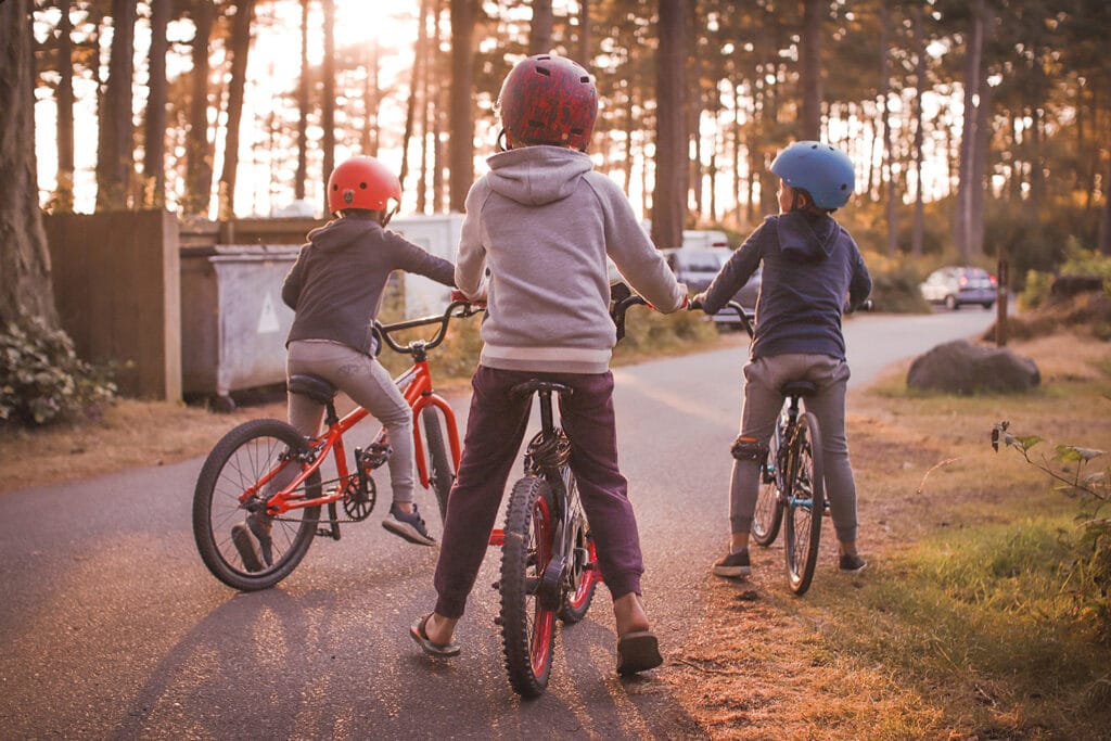 three little boys on bicycles