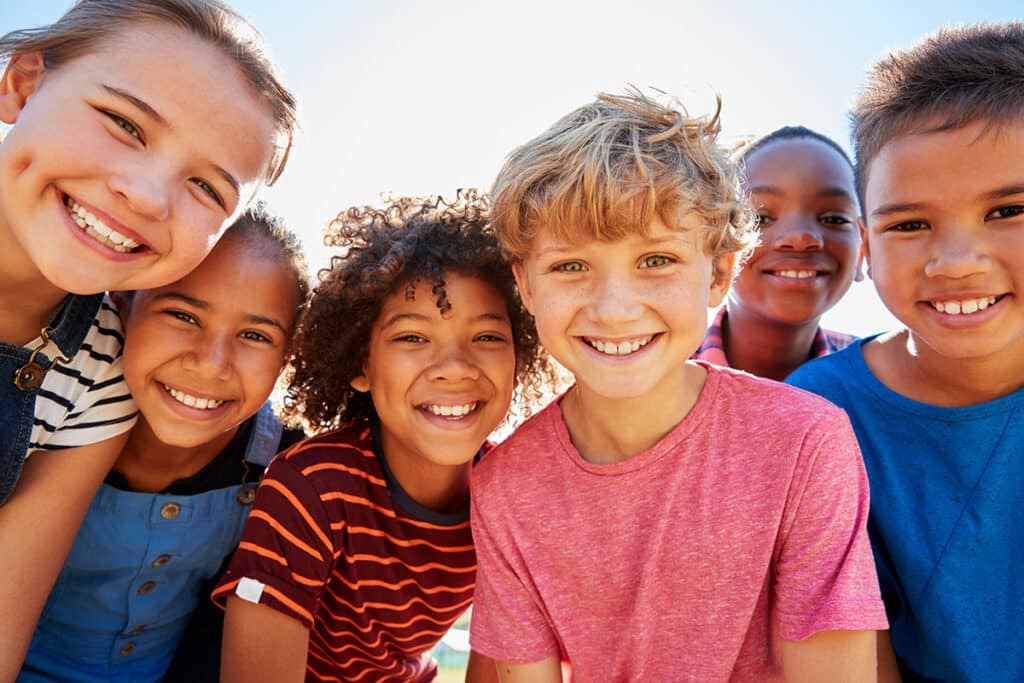 a group of six kids smiling at the camera