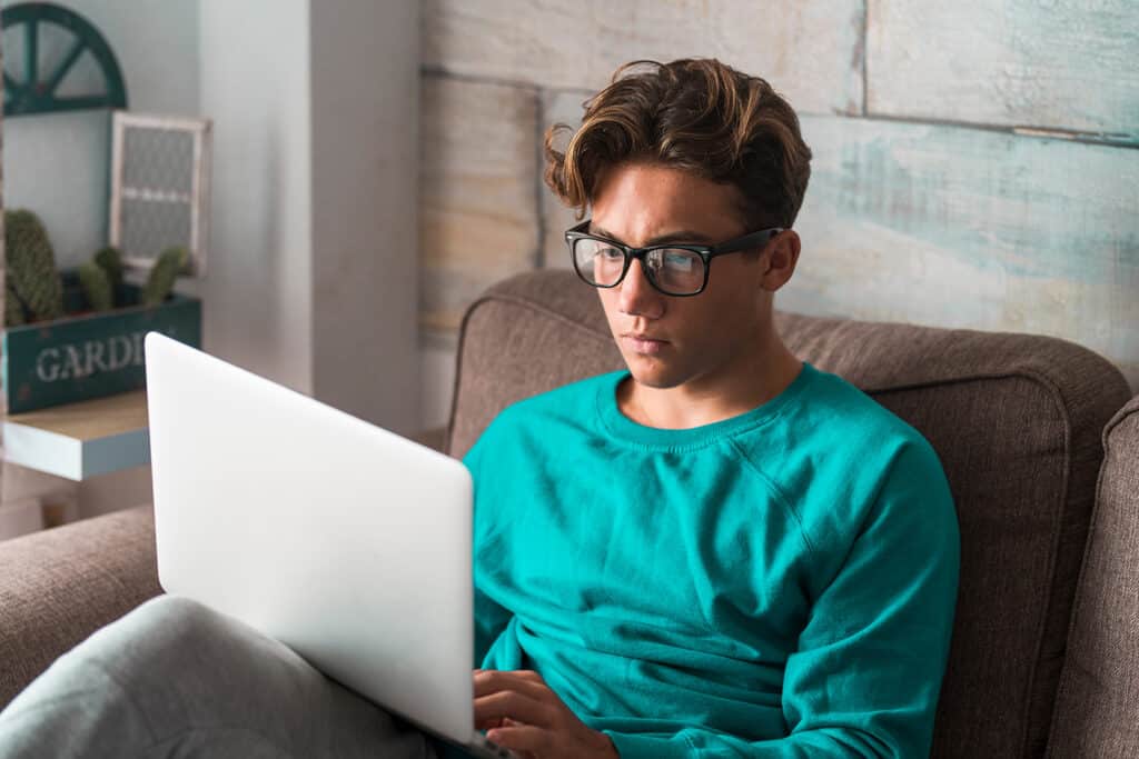 teen boy on his laptop